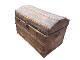 A domed top seamans chest with studded battens and iron mounts, having carriage handles to ends. (