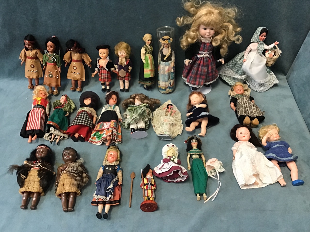 A collection of dolls, mainly in national costumes - Dutch, Welsh, Scottish, a Swiss guard, Māori,