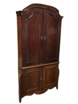 A C18th Dutch corner cabinet with shaped arched cornice above a pair of panelled doors with
