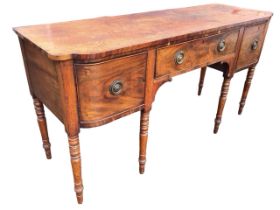 A regency mahogany sideboard with shaped rectangular rosewood crossbanded top above a cockbeaded