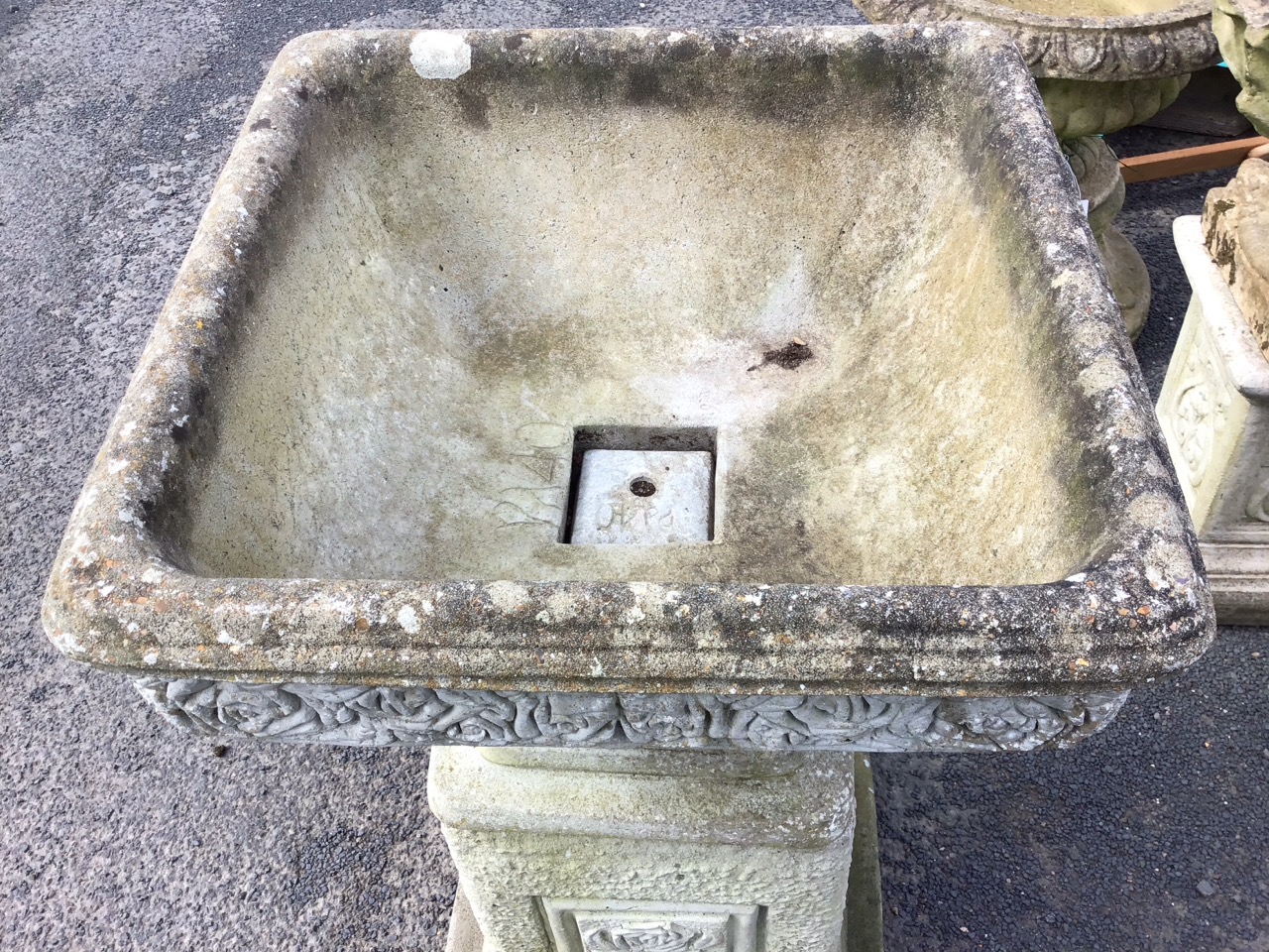 A square composition stone urn cast with frieze of roses above mottled body, supported on a square - Image 2 of 3