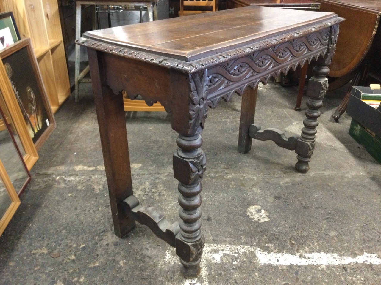 A Victorian oak jacobean style console table with rectangular leaf carved top above a waved ribbon - Image 3 of 3