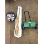 A quantity of 5ft bamboo garden poles; a Westland lawn fertiliser spreader; and an iron shell shaped