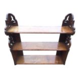 A set of Victorian mahogany hanging shelves with shaped scrolled foliate pierced sides flanking