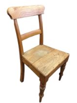 A Victorian elm and ash chair with shaped back and plain rail above a solid seat, raised on turned