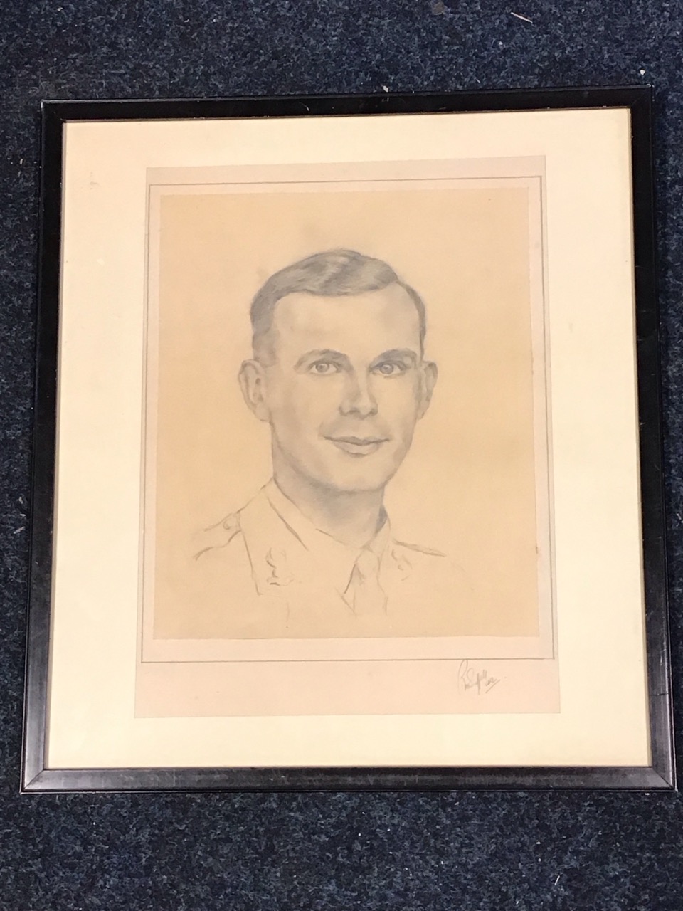 A pencil bust portrait of a young army officer, indistinctly signed, dated 42, mounted & framed. (