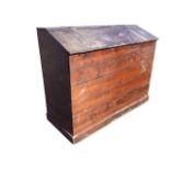 A tongue & groove boarded pine saddle bin, the angled lid with strap hinges, supported on a