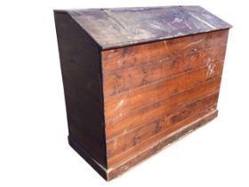 A tongue & groove boarded pine saddle bin, the angled lid with strap hinges, supported on a