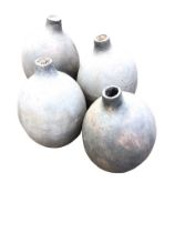 Four ovoid mis-shaped handmade pots with tubular apertures. (14in) (4)