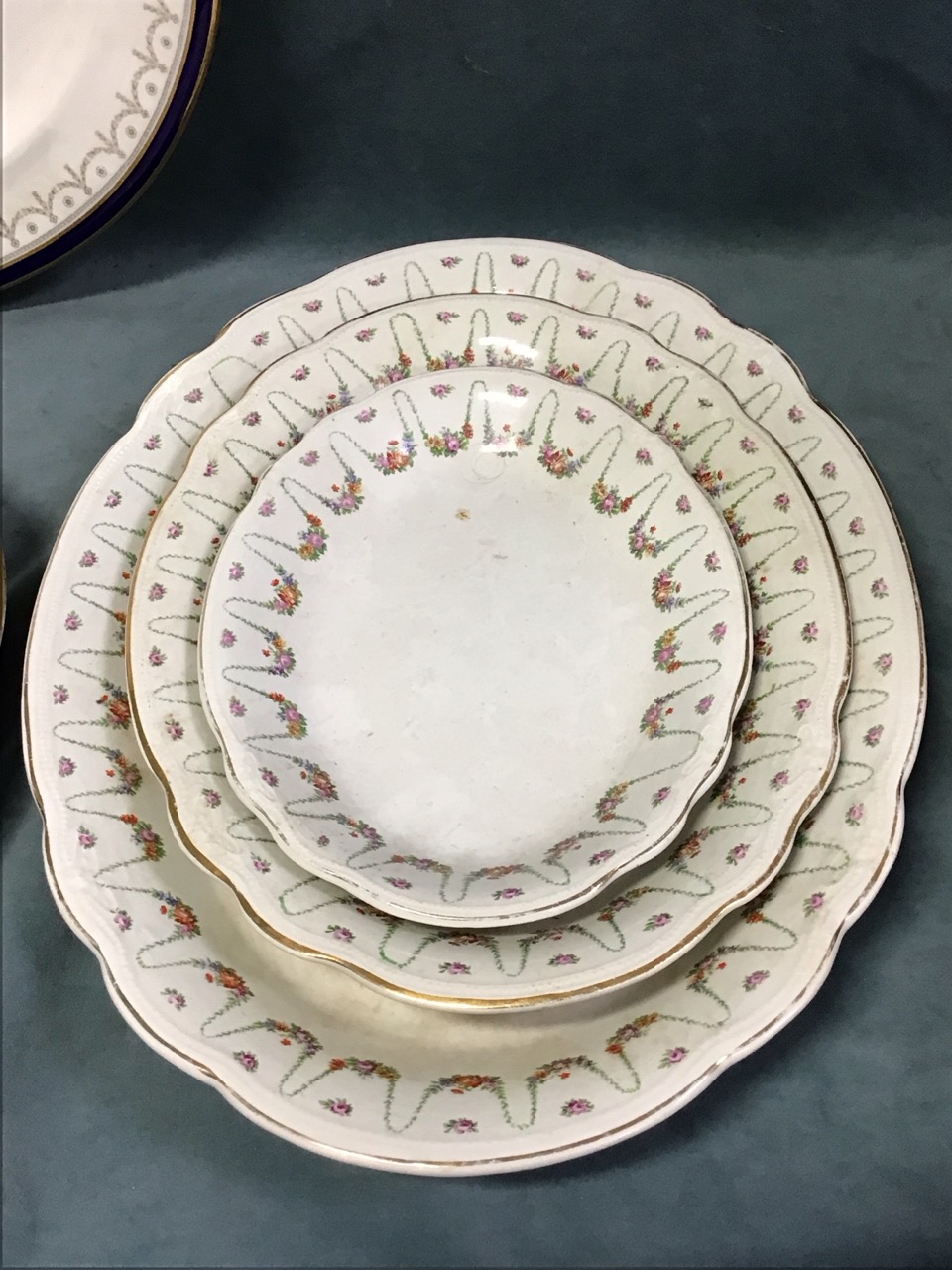 A set of three oval Adams ironstone graduated meat dishes with floral swag borders; a Booths ashet - Image 2 of 3