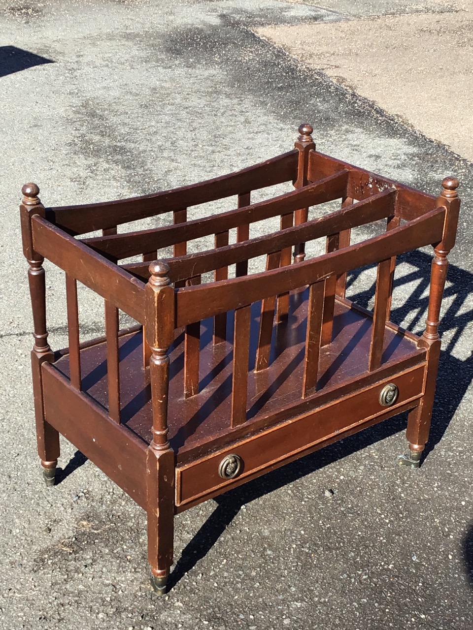 A Georgian style mahogany canterbury with three divisions framed by slats having turned