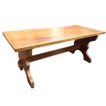 A contemporary mahogany refectory table with rectangular panelled top on shaped trestle supports