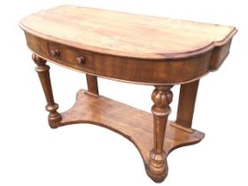 A Victorian mahogany bowfronted console table with moulded top above a cockbeaded frieze with