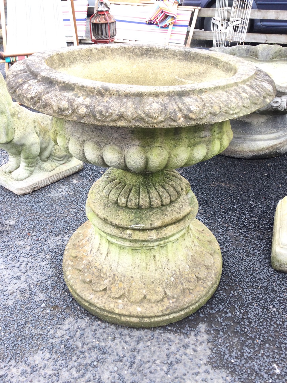 A composition stone urn with egg & dart moulded overhanging rim above a lobbed body and fluted - Image 3 of 3