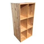 A pine shelf unit with six deep compartments. (22.75in x 19in x 49.75in)