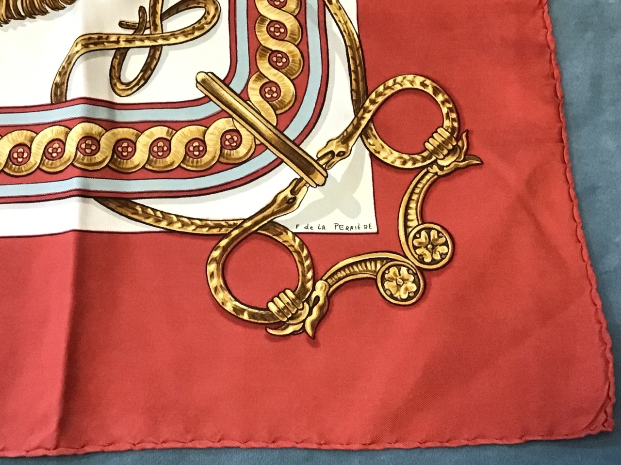 A Hermès Bride de Cour silk scarf, depicting a tasseled bridle on red ground, by F de La - Image 2 of 3