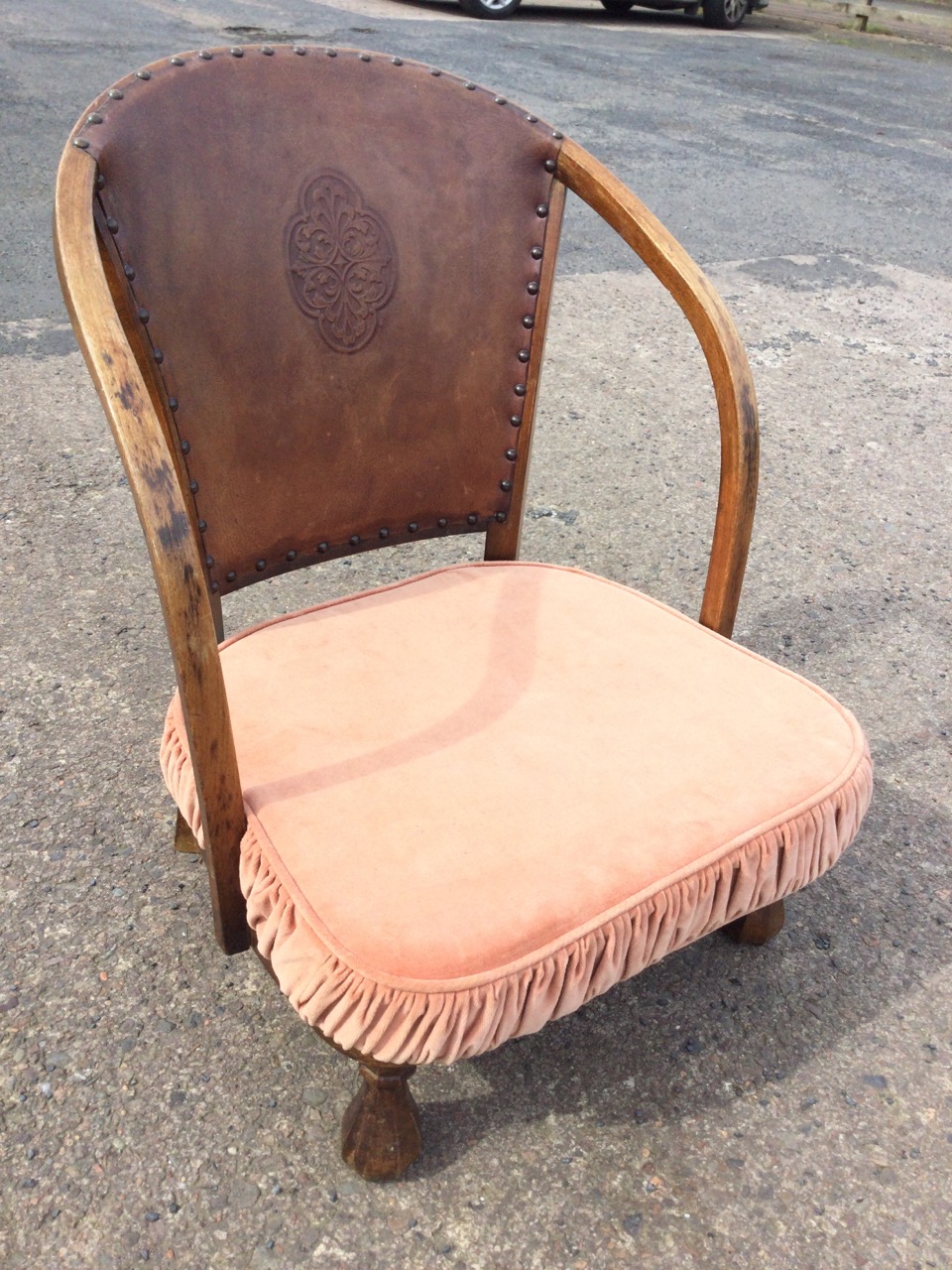 A 20s hardwood low armchair with studded embossed leather back and curved arms above a seat with - Image 3 of 3