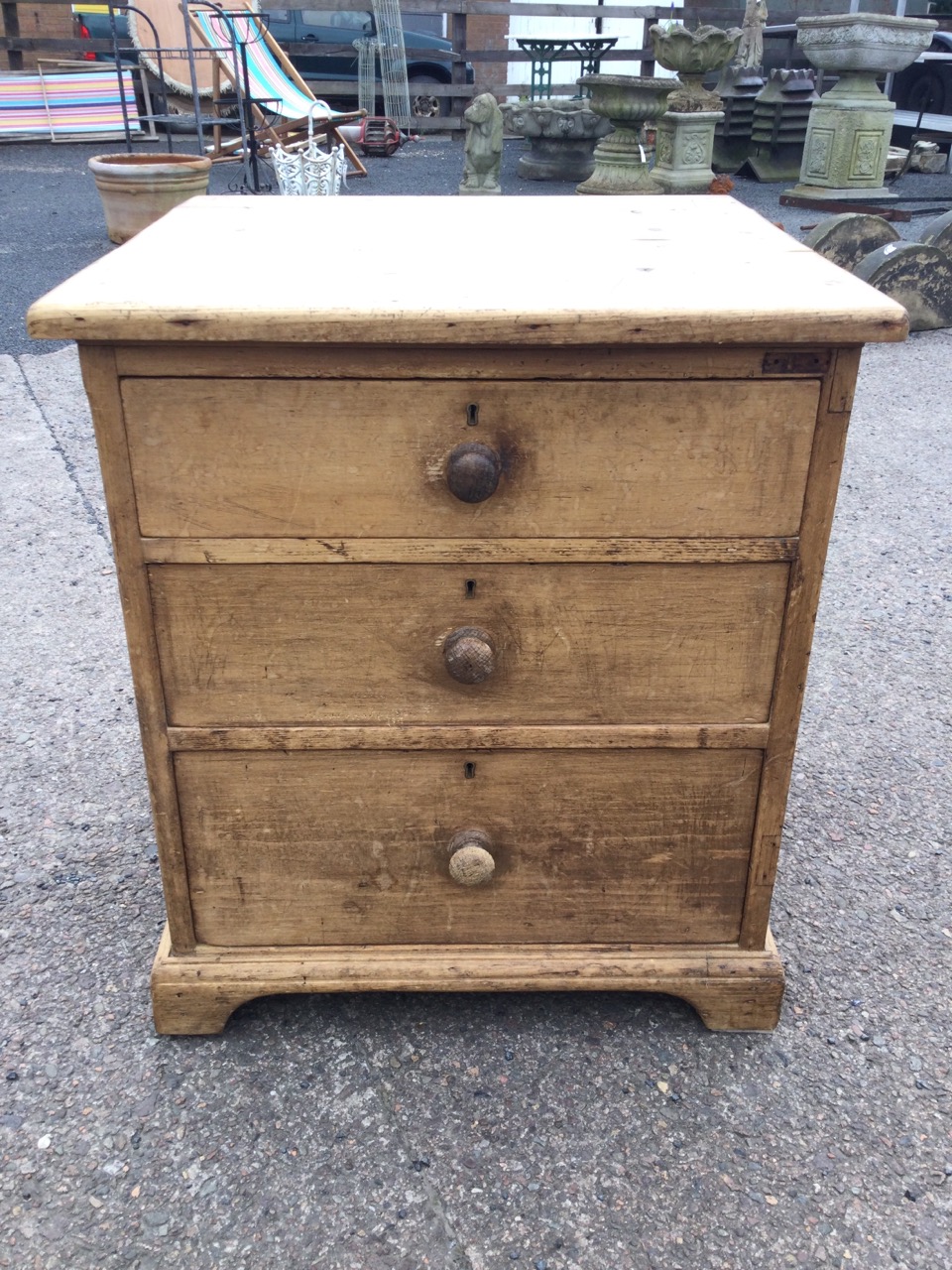 A Victorian pine chest of three graduated knobbed drawers having carriage handles to sides, raised - Image 2 of 3