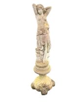 An art nouveau style composition stone garden statue of an elegant lady standing by urn on