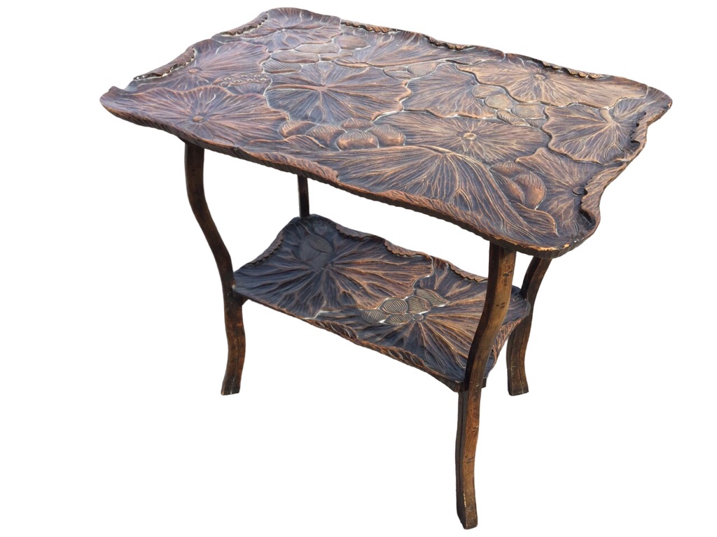 An early C20th Japanese hardwood occasional table with shaped rectangular top carved with lotus pads
