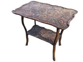 An early C20th Japanese hardwood occasional table with shaped rectangular top carved with lotus pads