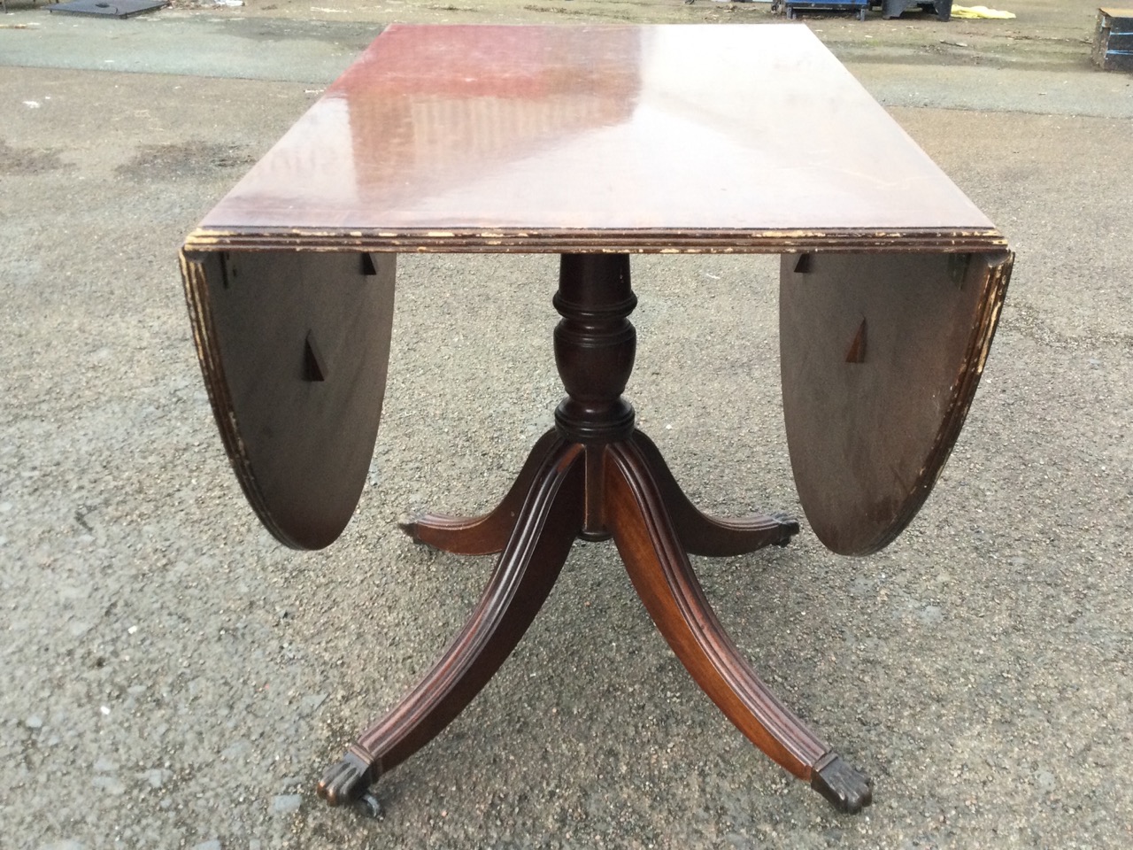A Georgian style mahogany dropleaf dining table, the crossbanded top with two demi-lune leaves - Image 3 of 3