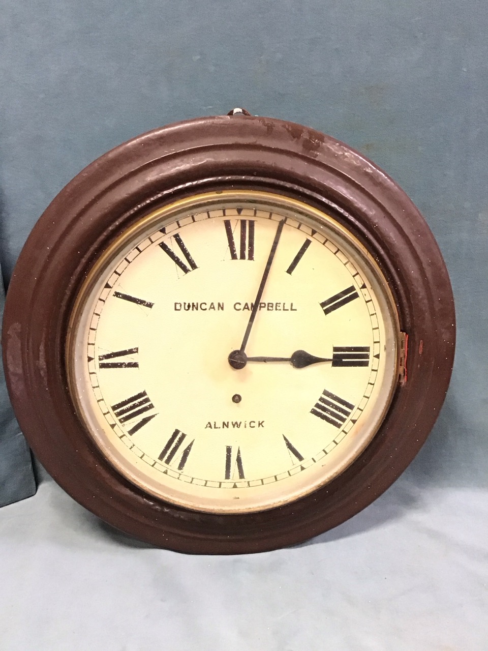 A Victorian circular wall clock by Duncan Campbell - Alnwick, with moulded metal case and glazed