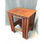 A mahogany nest of three tables with rectangular tops raised on grooved square legs joined by