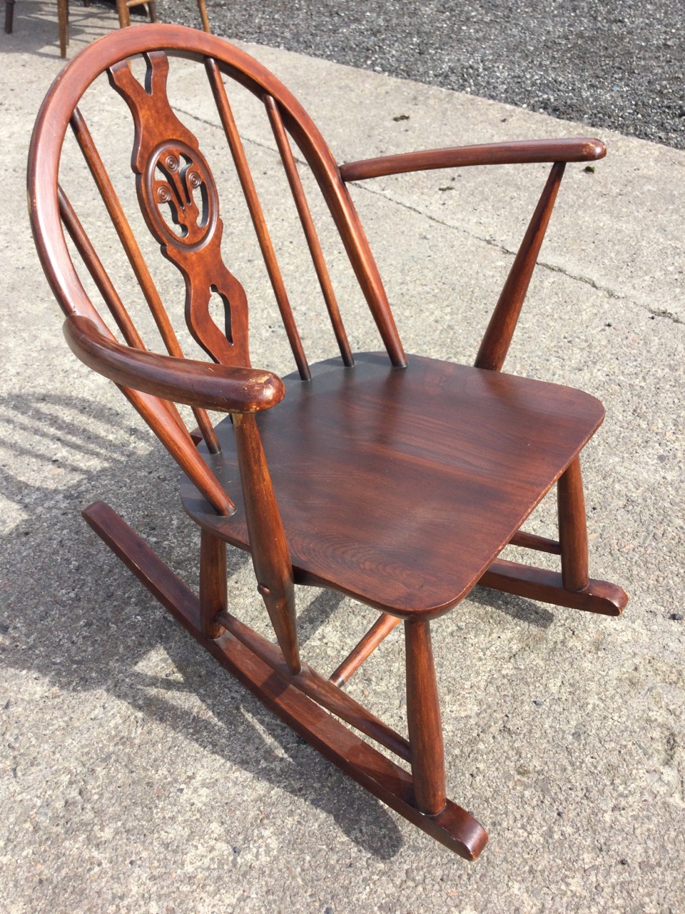 An Ercol elm & beech rocking chair with arched spindled back and Prince of Wales feather pierced - Image 3 of 3