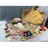 Miscellaneous militaria including cloth badges & insignia, uniform buttons, a shell fragment, WWII