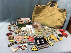 Miscellaneous militaria including cloth badges & insignia, uniform buttons, a shell fragment, WWII