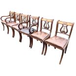 A set of six regency style mahogany dining chairs with lyre backs framed by reeded frames above
