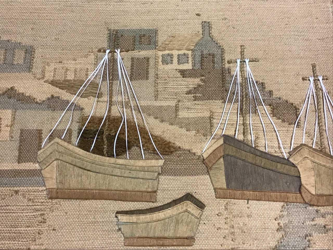 Mixed technique natural fibre tapestry wall hanging depicting boats in a harbour with cottages and a - Image 3 of 3