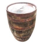 A bulbous oak whisky barrel with staves bound by six riveted metal strap bands. (34.75in)