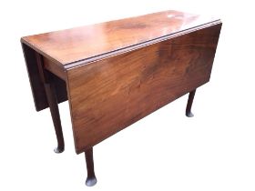 A Georgian mahogany dropleaf dining table, the rectangular top with two leaves supported on swing