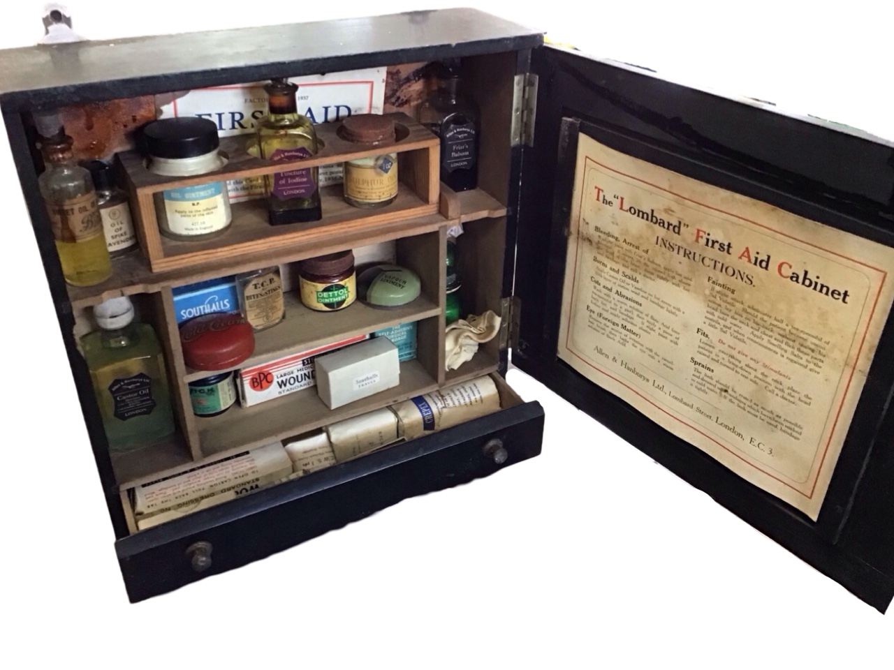 An Edwardian hanging ebonised first aid cabinet - The Lombard, with brass knobbed panelled door - Image 2 of 3