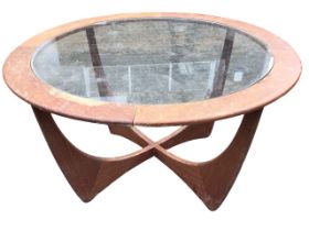 A 70s Gplan teak coffee table with plate glass panel in circular moulded frame, raised on four
