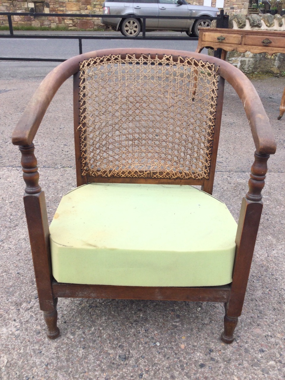 A 20s beech low armchair with caned horseshoe shaped back, and arms on turned supports, above a - Image 2 of 3