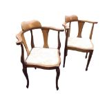 An Edwardian mahogany corner chair with shaped inlaid backrest on horseshoe shaped arms with