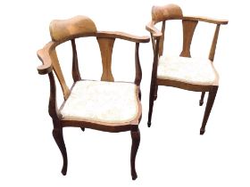 An Edwardian mahogany corner chair with shaped inlaid backrest on horseshoe shaped arms with