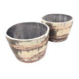 A pair of oak whisky barrel garden tubs, the staves bound by three riveted metal strap bands. (17.