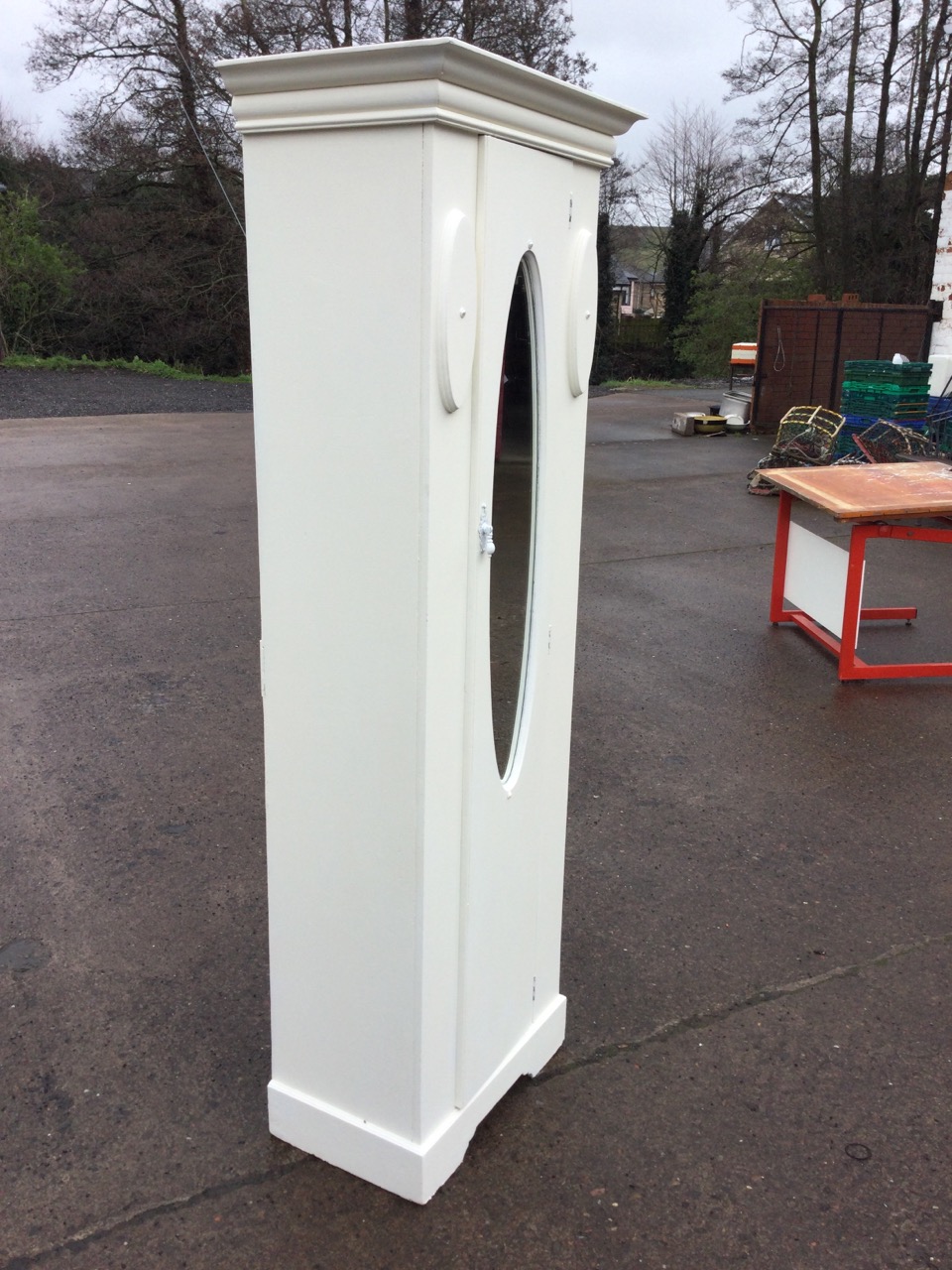 An Edwardian painted wardrobe with moulded cornice above a door with oval bevelled mirror opening to - Image 2 of 3