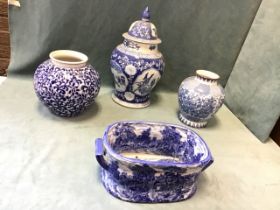 A Chinese porcelain covered baluster jar decorated with panels of birds and figures on a floral