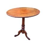 An oval Victorian mahogany occasional table supported on a turned tapering column with scrolled