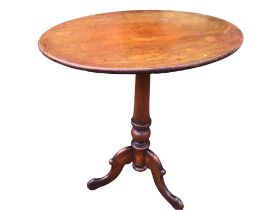 An oval Victorian mahogany occasional table supported on a turned tapering column with scrolled