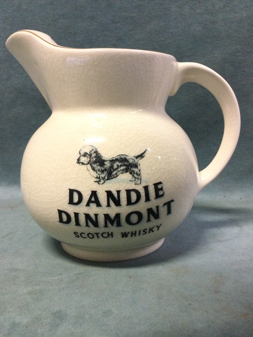A Wade whisky water jug with Dandie Dinmont decoration and gilt rims; and a MacAllan whisky jug. ( - Image 2 of 3