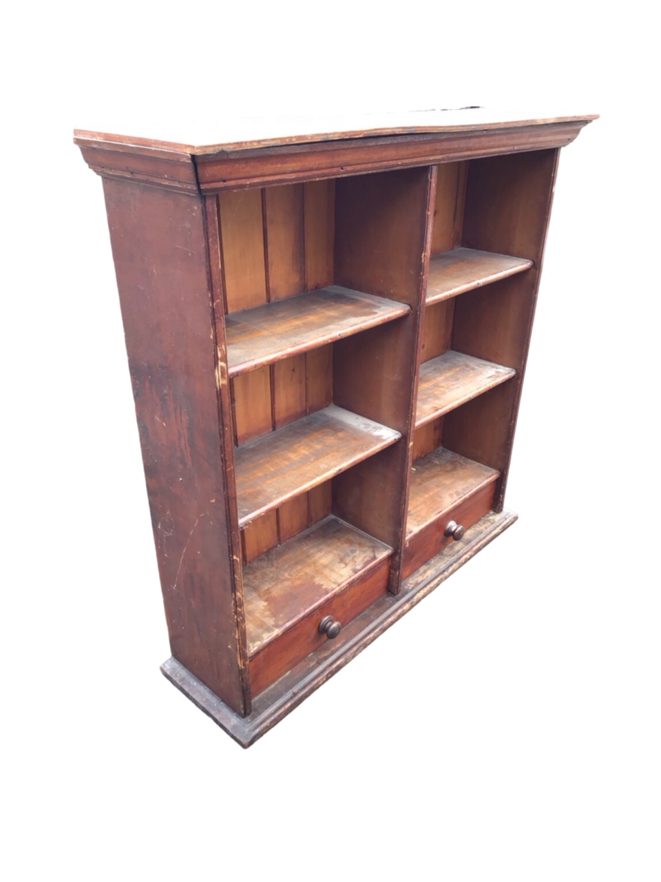 A Victorian mahogany bookcase with moulded cornice above open shelves and tongue & grooved back, the