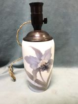 A Royal Copenhagen porcelain tablelamp, the tapering body decorated with an orchid, with patinated