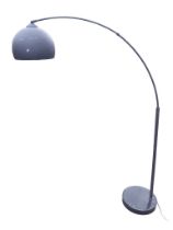 A 60s style lamp with bowl shaped shade on arched tubular support above a circular weighted base. (