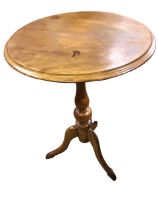A circular nineteenth century mahogany occasional table with moulded top on vase shaped turned